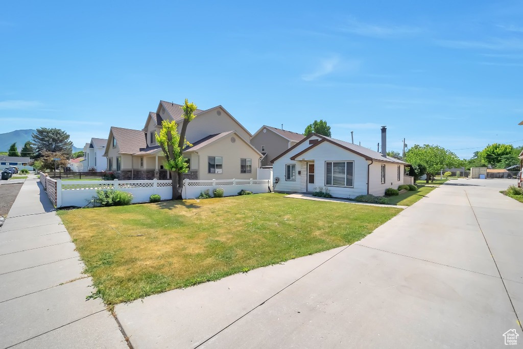 View of front of property featuring a residential view and concrete driveway