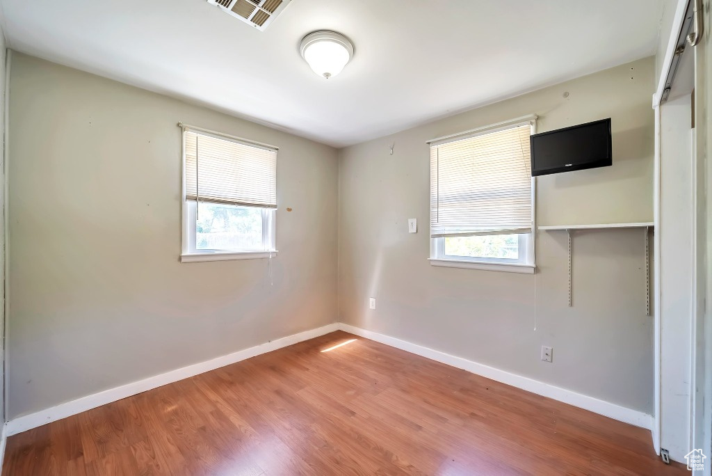 Spare room with wood finished floors and baseboards