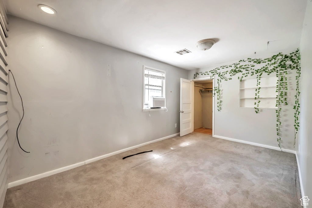 Unfurnished bedroom with light colored carpet and a closet
