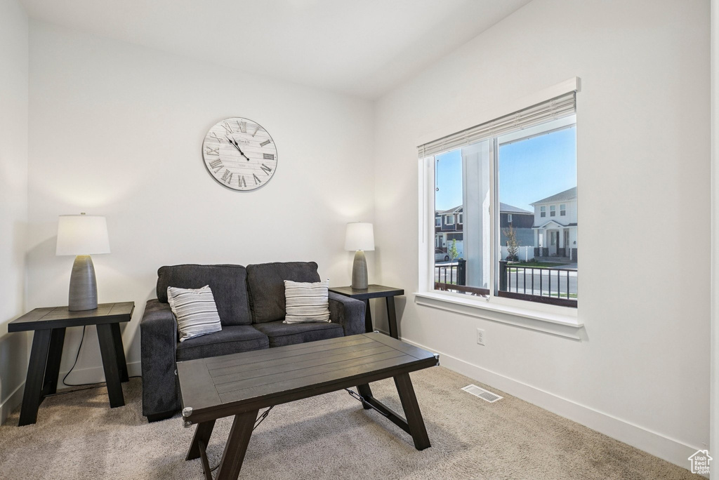 Carpeted living room with baseboards
