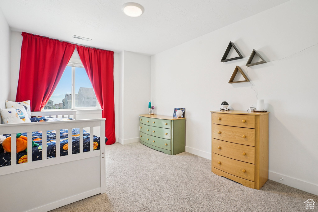 Carpeted bedroom featuring baseboards