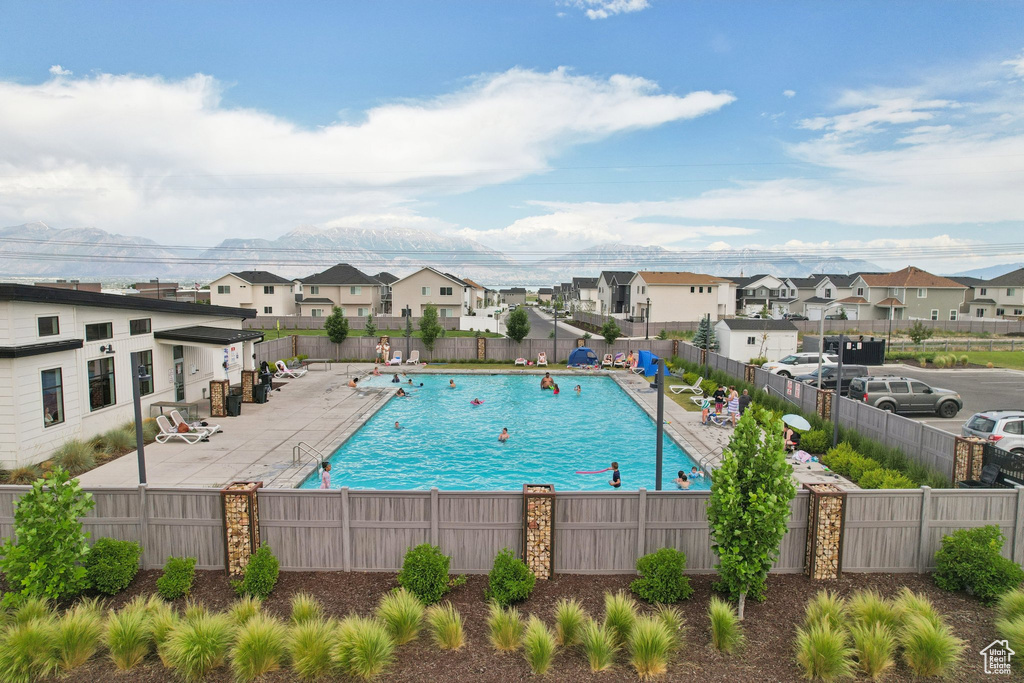Community pool featuring a residential view and a patio area