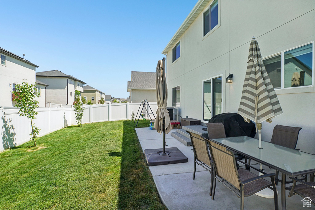 View of yard with a patio area, a residential view, and outdoor dining space