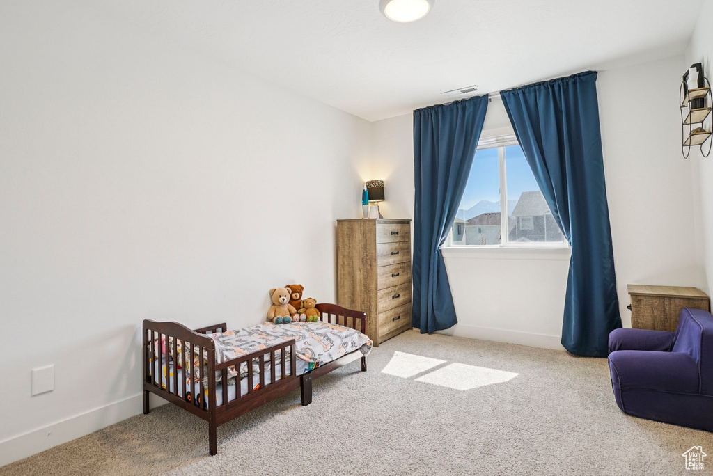 Carpeted bedroom featuring baseboards