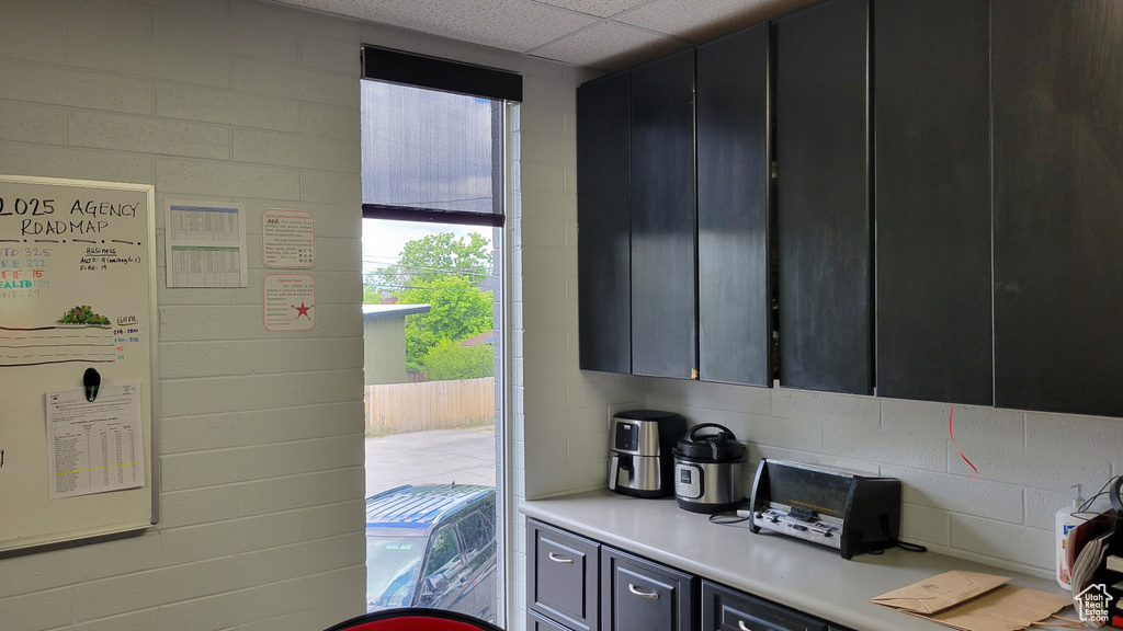 Kitchen with light countertops and dark cabinets