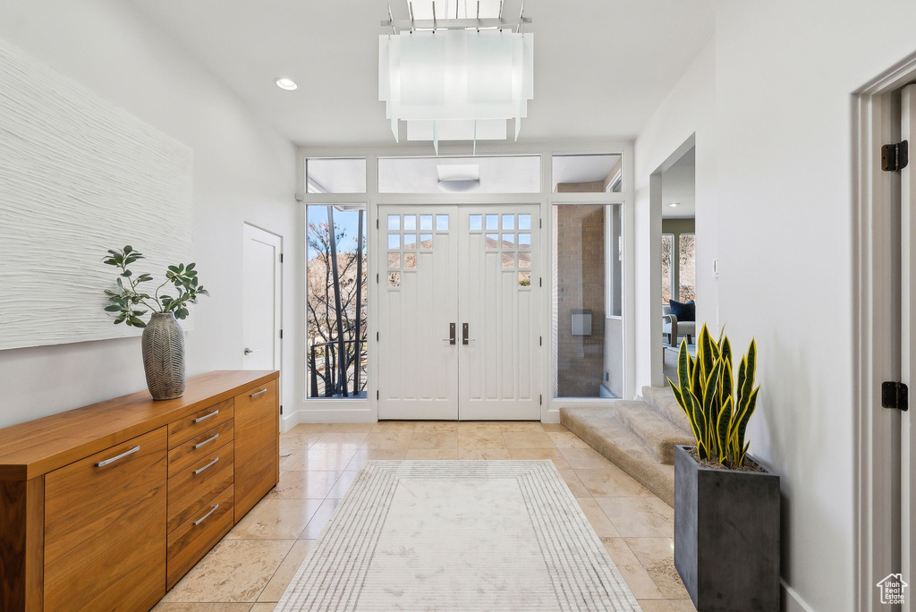Foyer entrance featuring baseboards and light tile patterned flooring