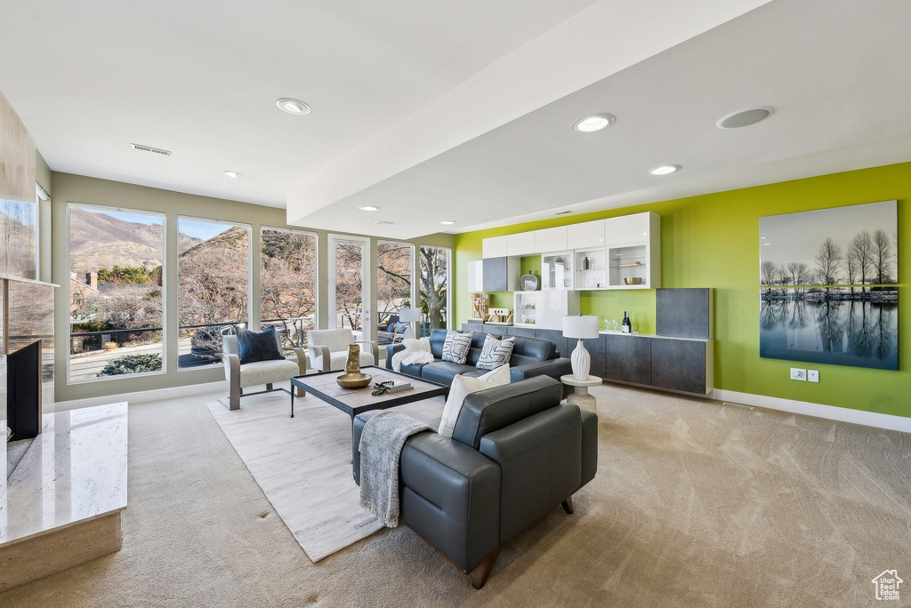 Carpeted living room featuring baseboards and recessed lighting