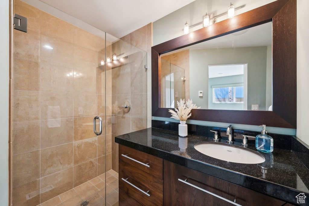 Full bath featuring vanity and a shower stall