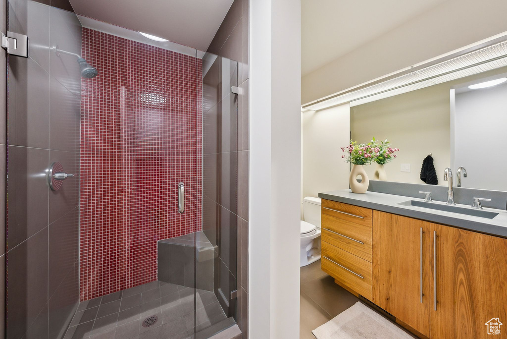 Full bathroom featuring a stall shower and vanity
