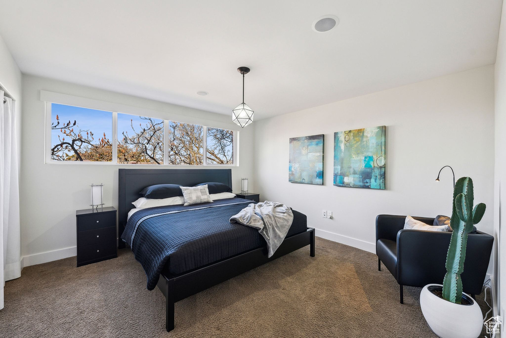 Bedroom with baseboards and carpet floors
