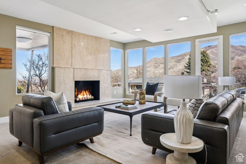 Living room with a mountain view, a fireplace, carpet flooring, and recessed lighting