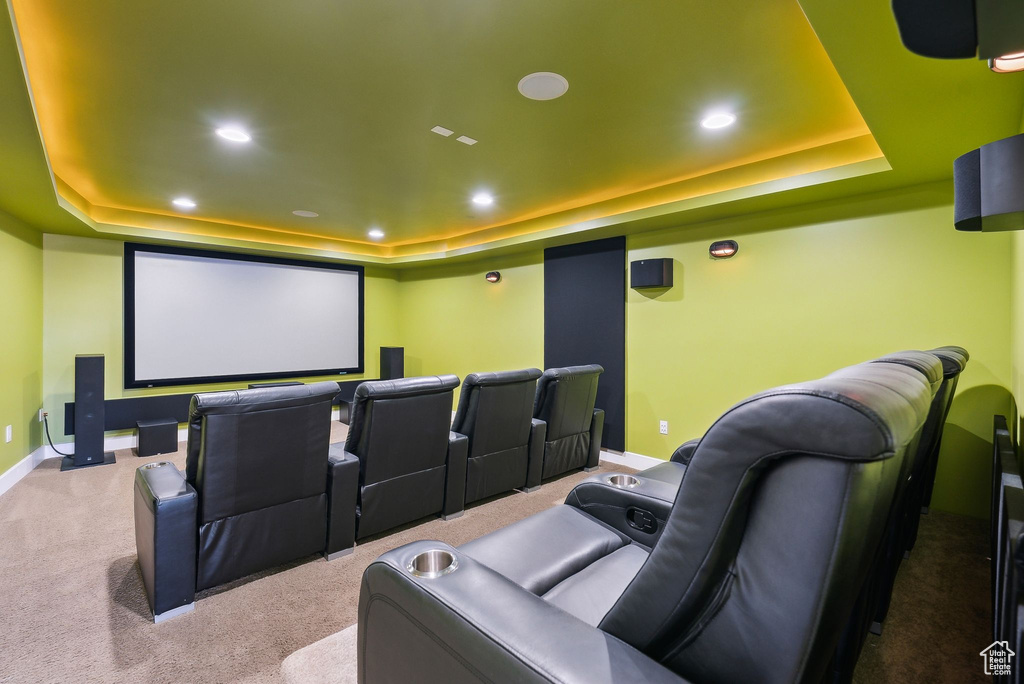 Home theater featuring a tray ceiling, carpet, and recessed lighting