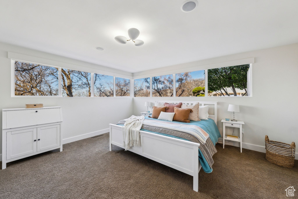 Carpeted bedroom featuring baseboards