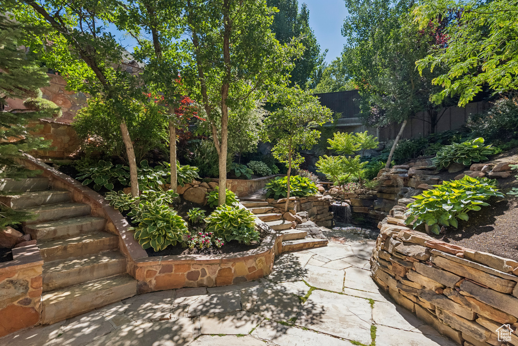 Fenced backyard with a patio area and stairway