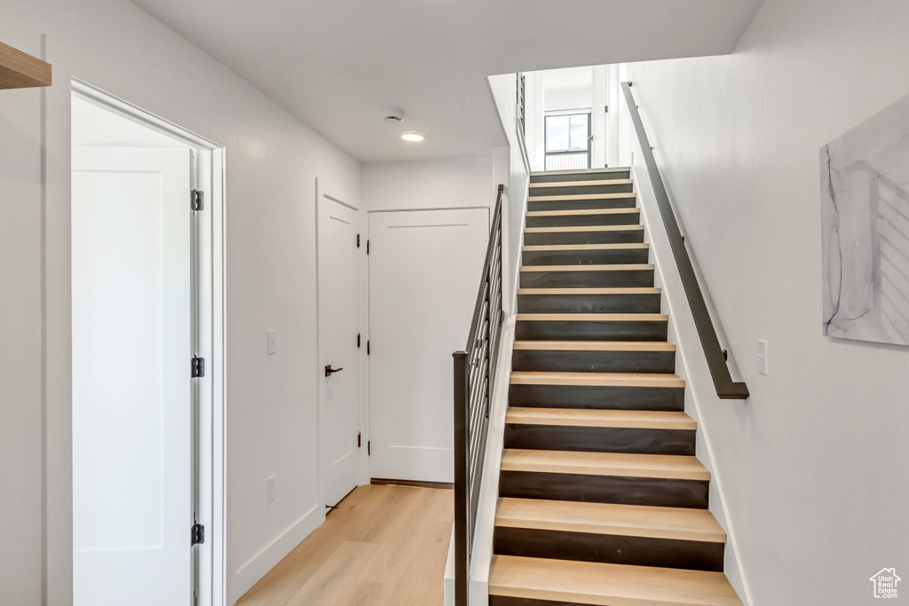 Stairway featuring wood finished floors and baseboards