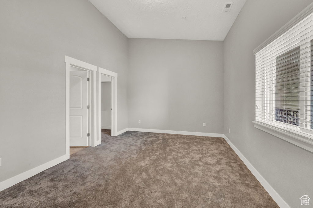 Unfurnished room featuring carpet flooring and baseboards