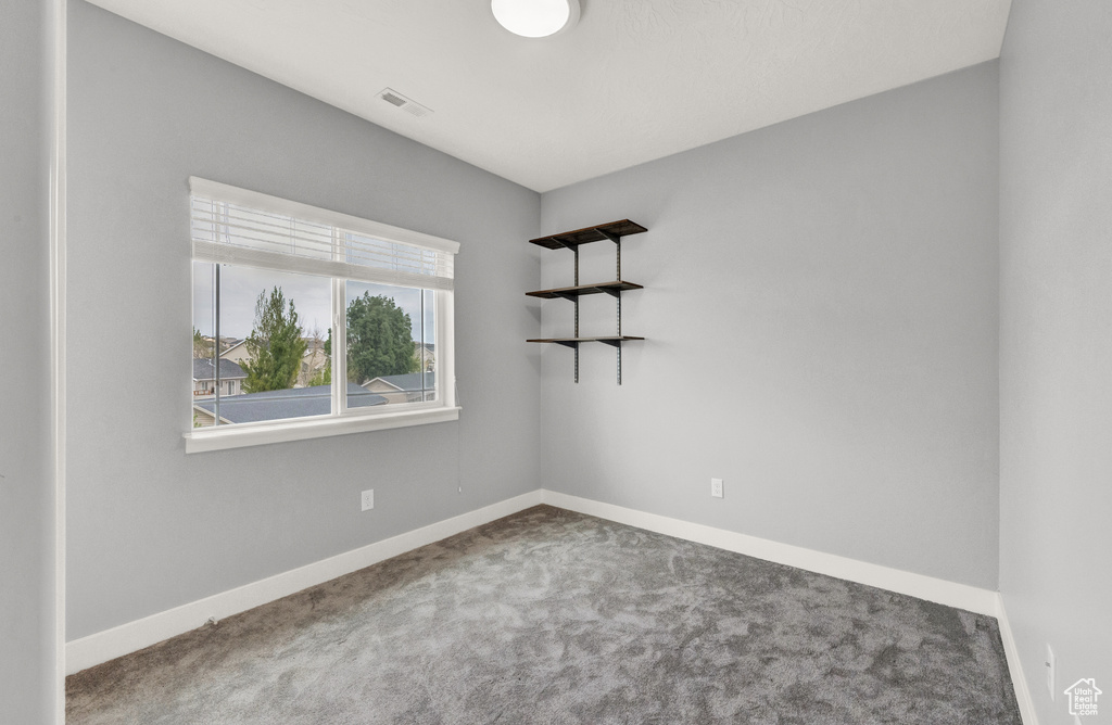 Unfurnished room featuring carpet flooring and baseboards