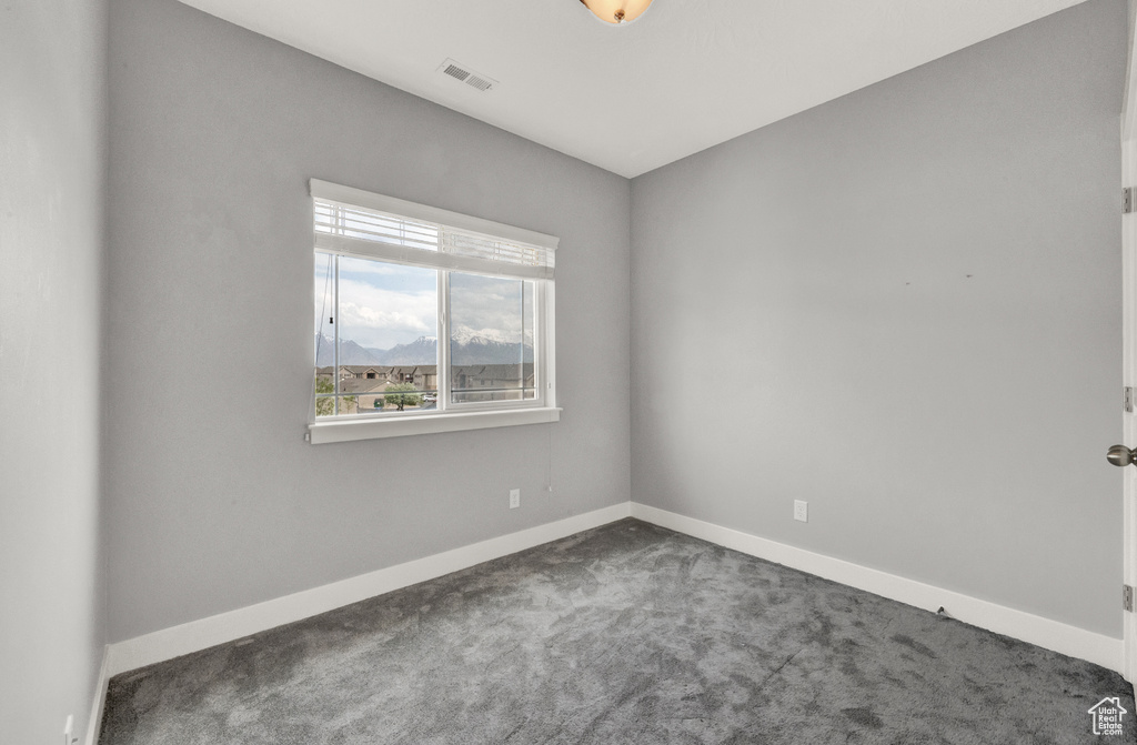 Carpeted empty room with baseboards