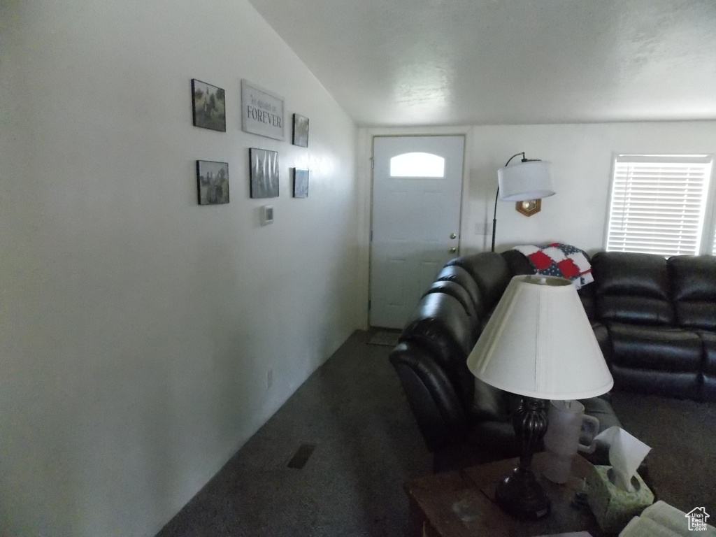 Carpeted living area with healthy amount of natural light