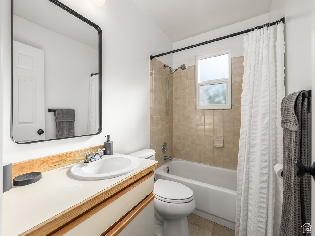 Full bath featuring shower / bathtub combination with curtain and vanity