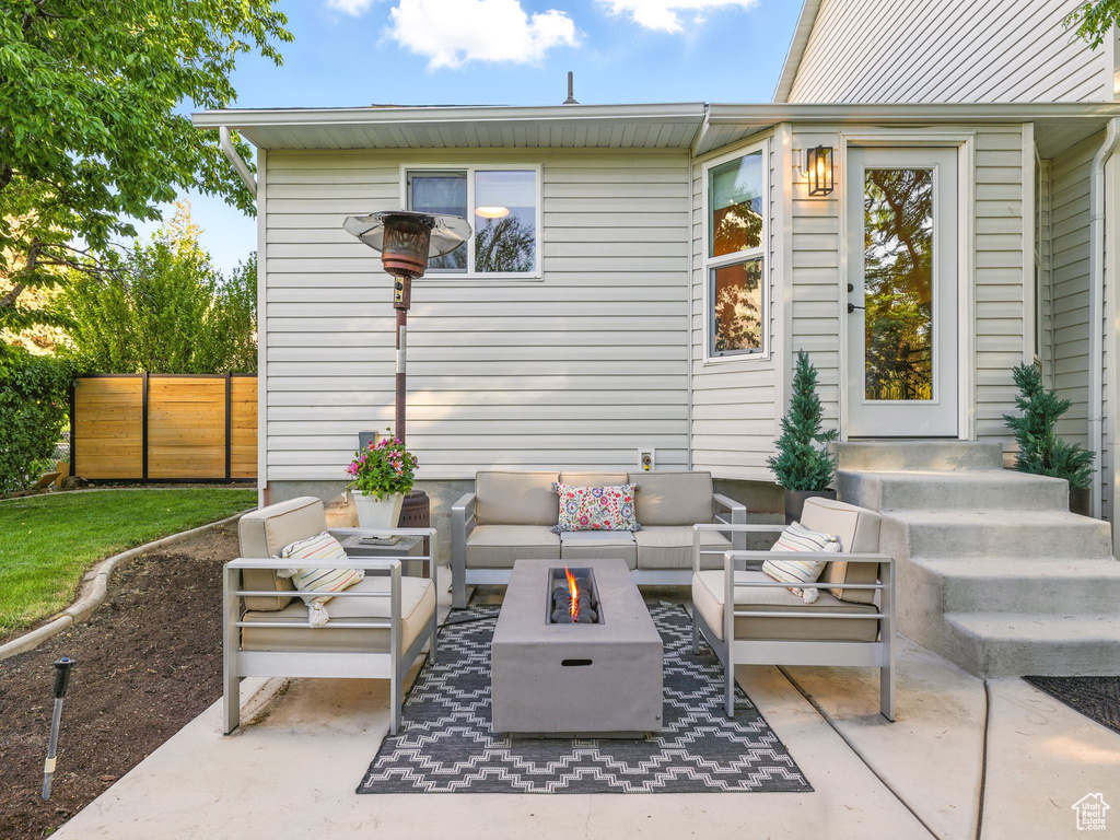 View of patio featuring an outdoor living space with a fire pit