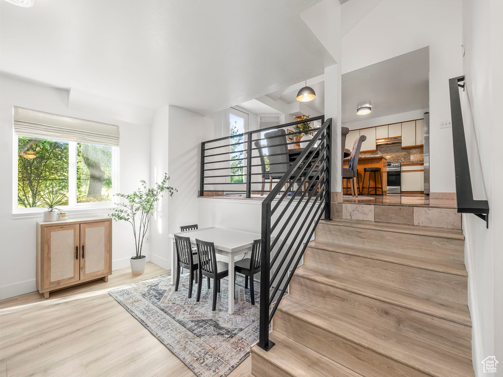 Stairs featuring wood finished floors and baseboards