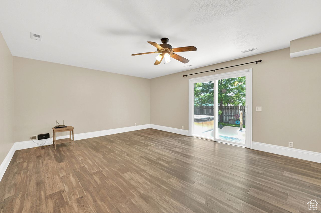 Unfurnished room with a ceiling fan and wood finished floors