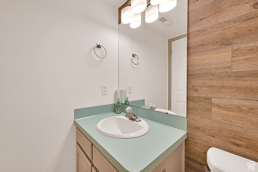 Bathroom with vanity and a chandelier