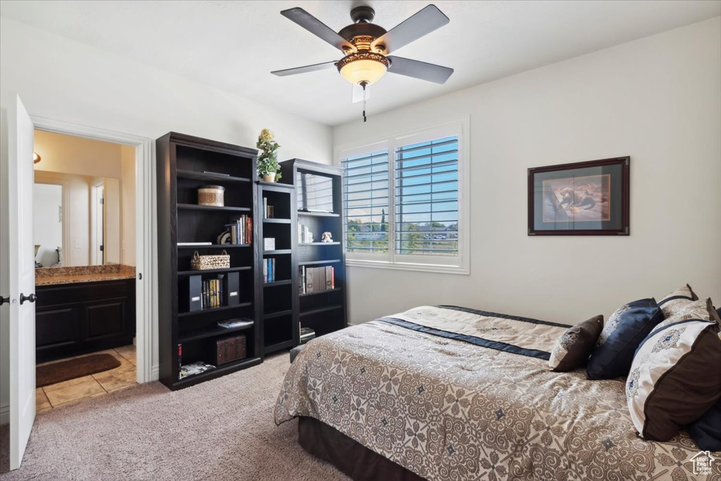 Bedroom with carpet, ensuite bathroom, and ceiling fan