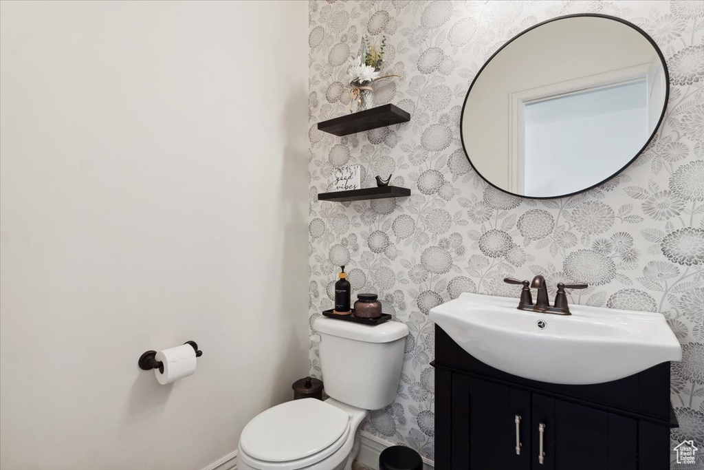 Bathroom featuring vanity and wallpapered walls