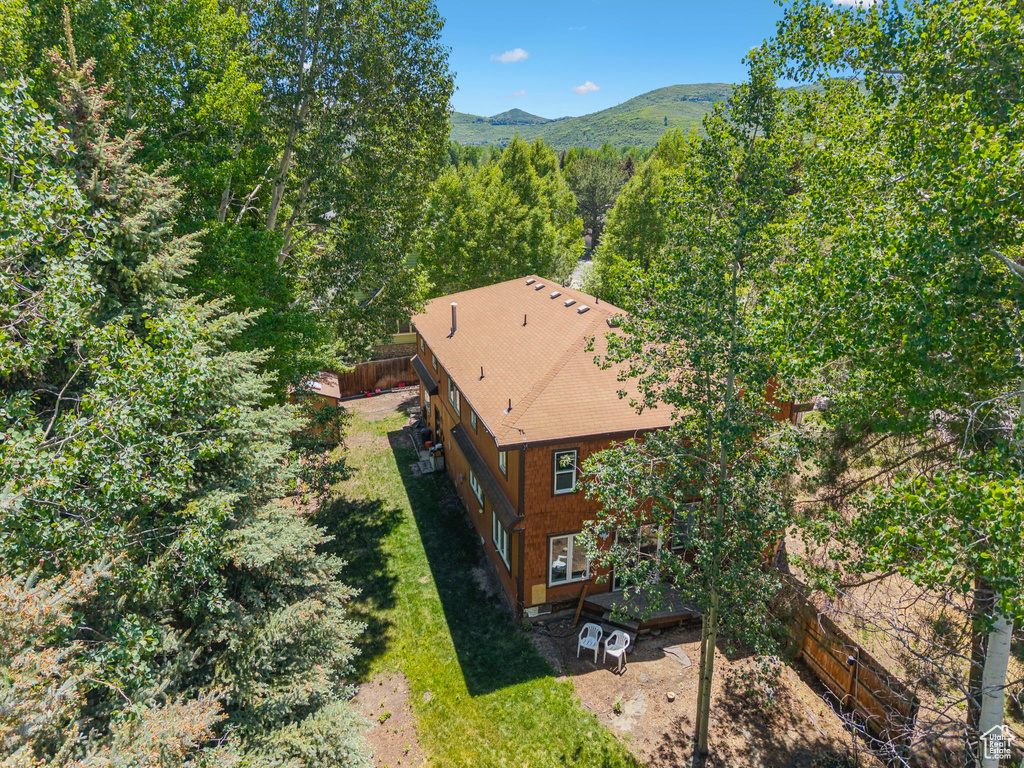 Aerial view of property and surrounding area featuring a mountainous background