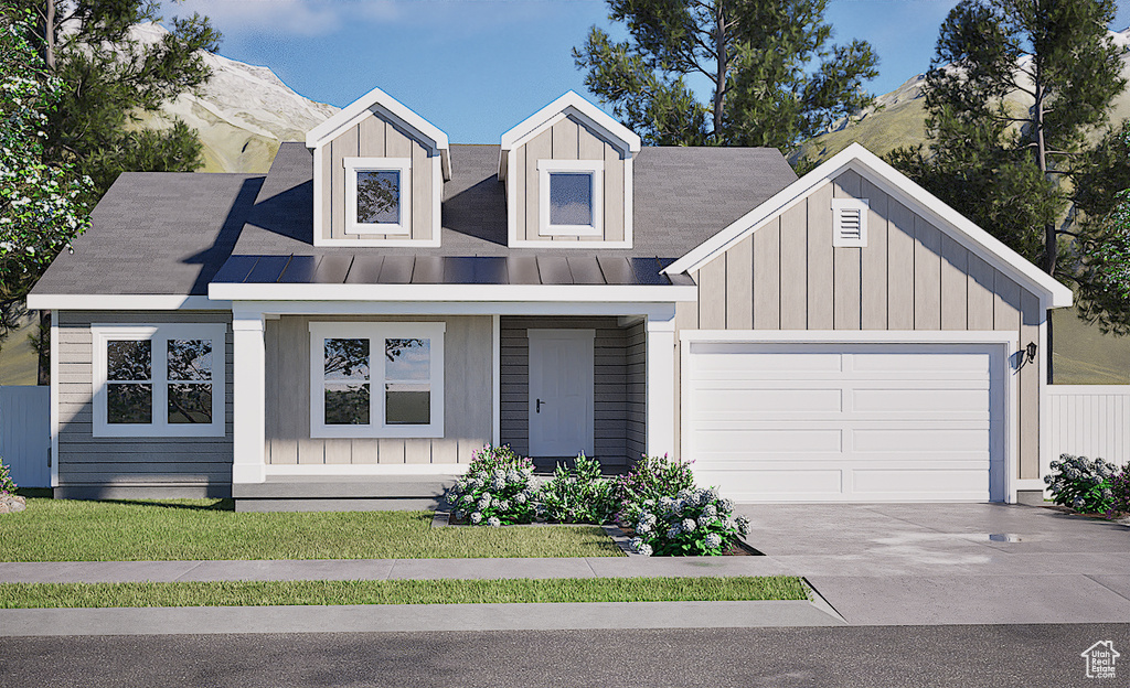 Modern farmhouse featuring driveway, a garage, board and batten siding, and a mountain view