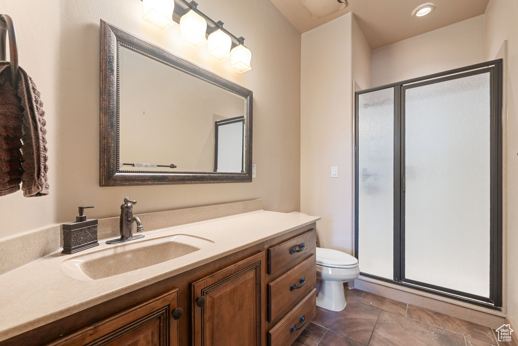 Full bath with vanity and a shower stall