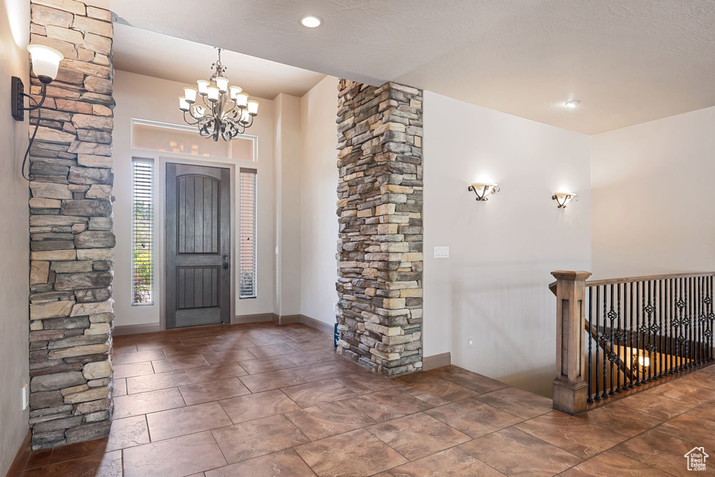 Entryway with a chandelier and decorative columns