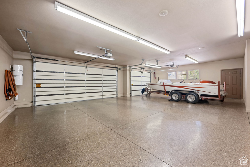 Garage featuring a central vacuum unit and a garage door opener