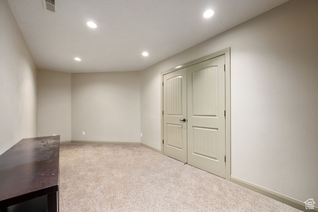 Below grade area with carpet flooring and recessed lighting