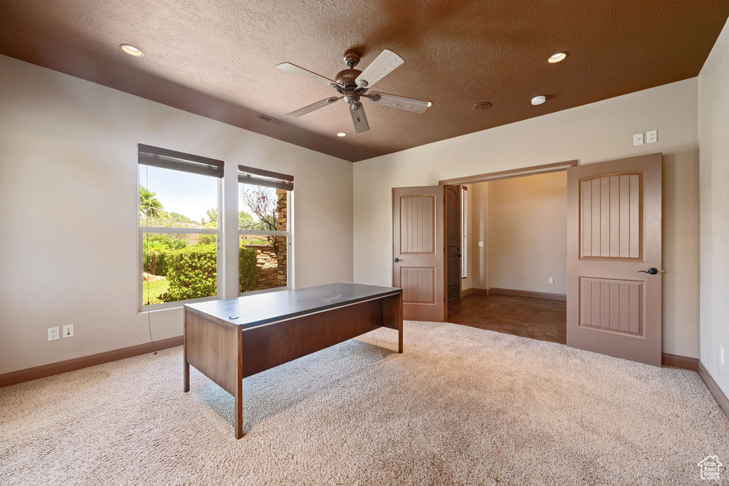 Unfurnished office with light carpet, ceiling fan, a textured ceiling, and recessed lighting