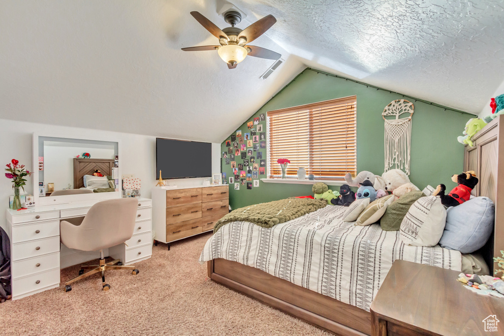 Bedroom with carpet floors, vaulted ceiling, and ceiling fan