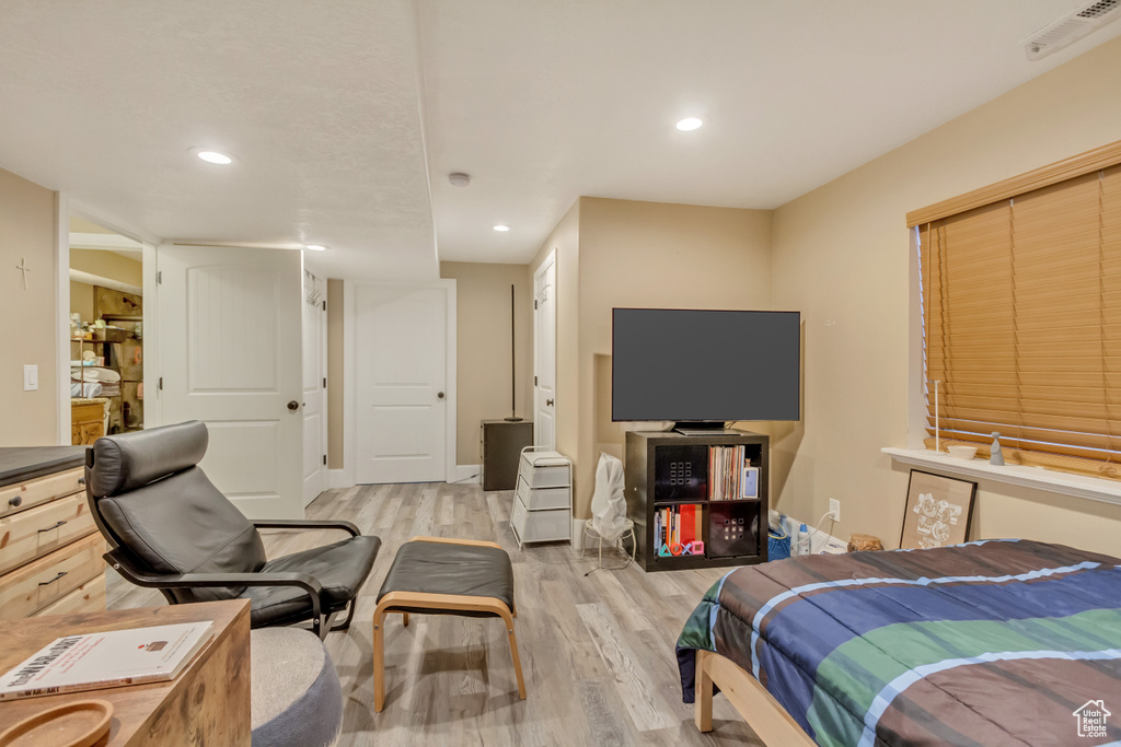 Bedroom with light wood-style floors and recessed lighting