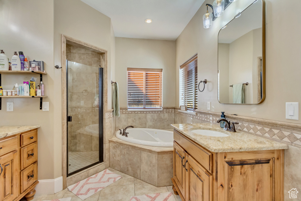 Bathroom with vanity, a bath, a stall shower, and tile patterned floors