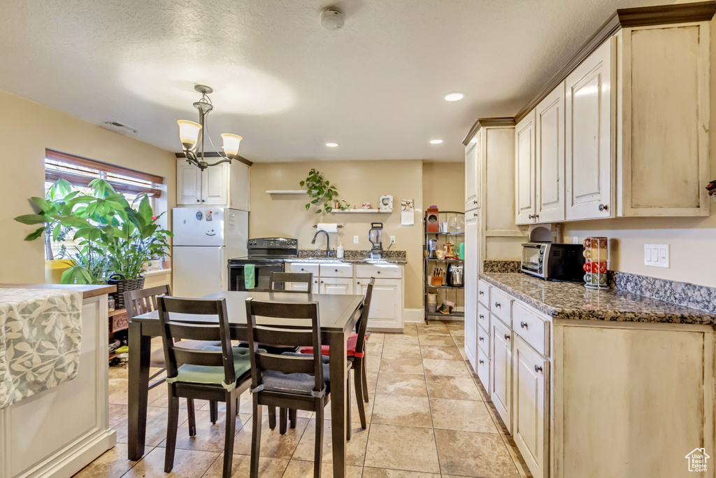 Dining area featuring a chandelier and recessed lighting