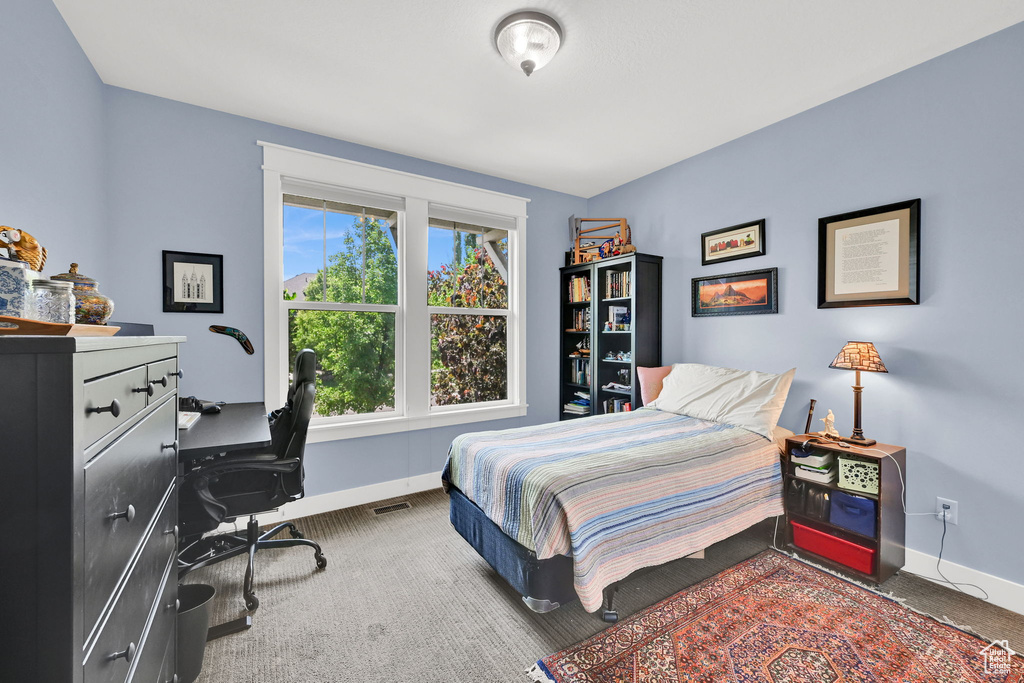 Bedroom with carpet and a desk