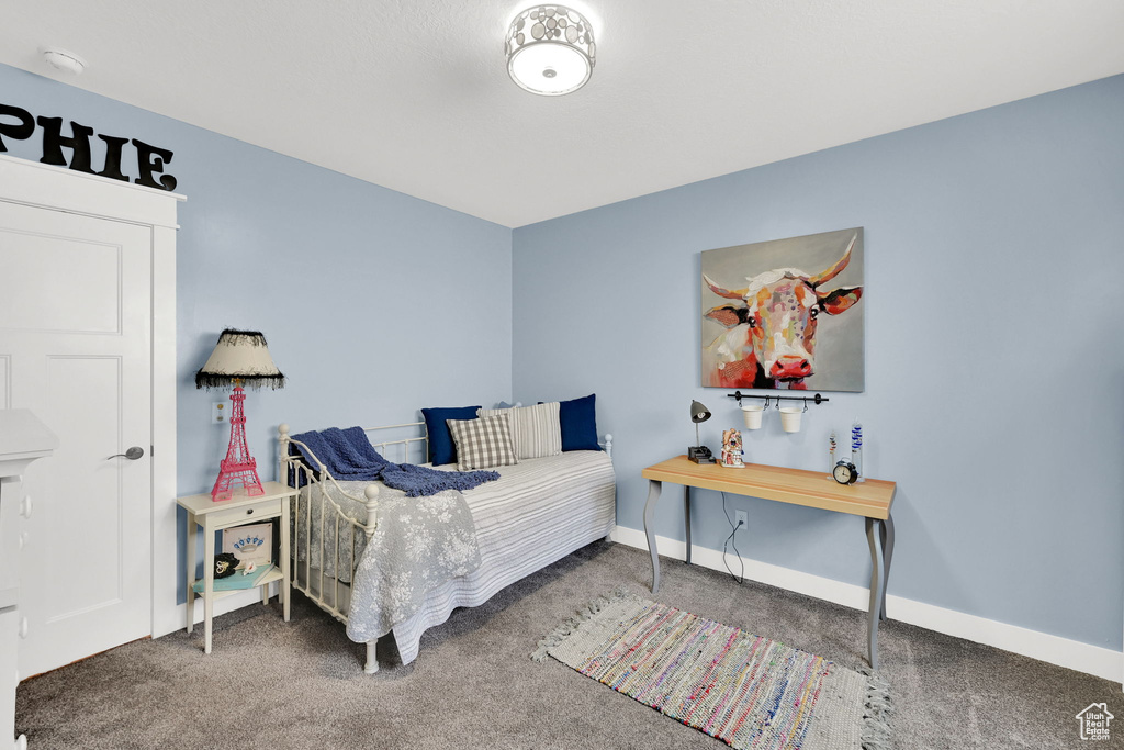 Bedroom featuring carpet flooring and baseboards