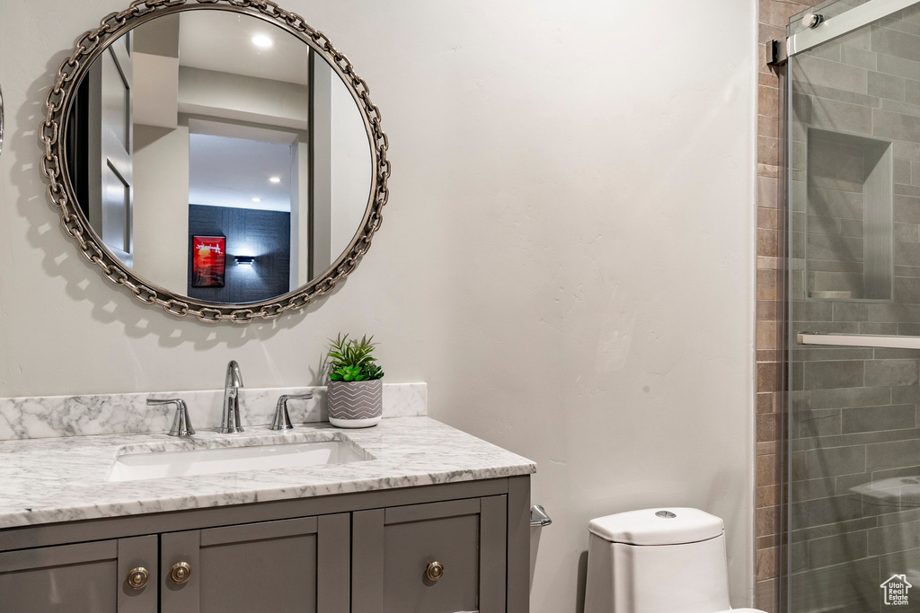 Full bathroom featuring vanity and tiled shower