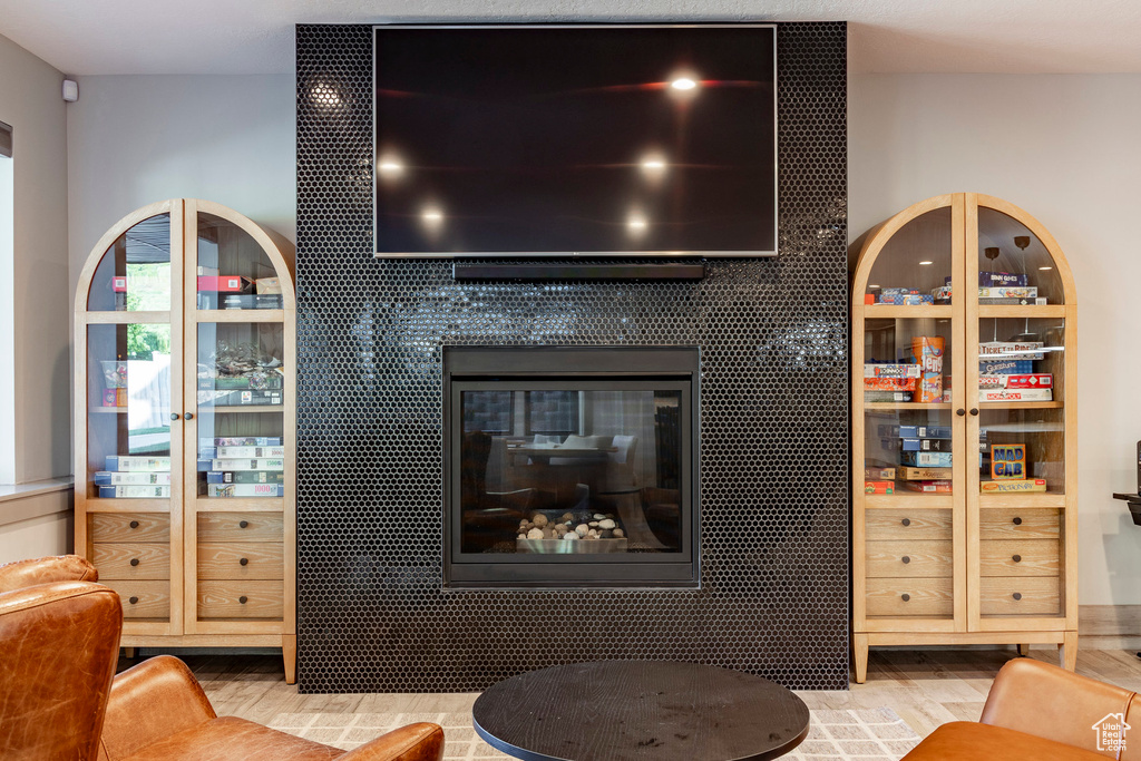 Living room featuring a tile fireplace and wood finished floors