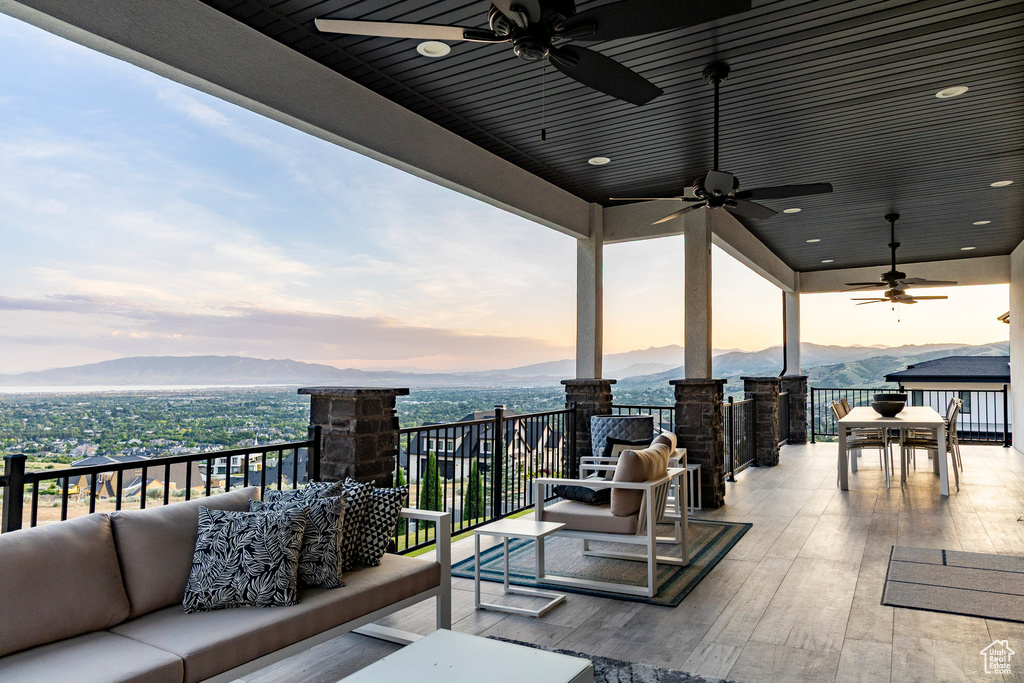 Patio / terrace with an outdoor hangout area, a mountain view, and ceiling fan