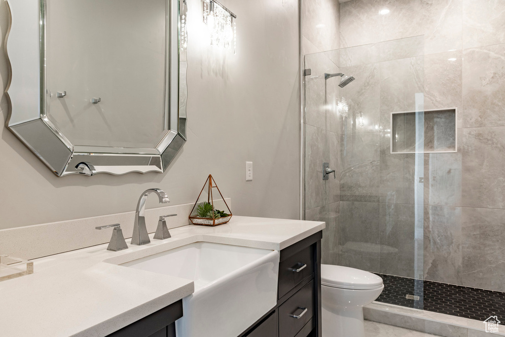 Bathroom featuring vanity and tiled shower