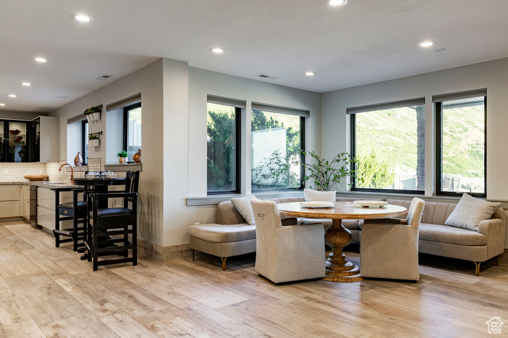 Dining space featuring recessed lighting and light wood finished floors