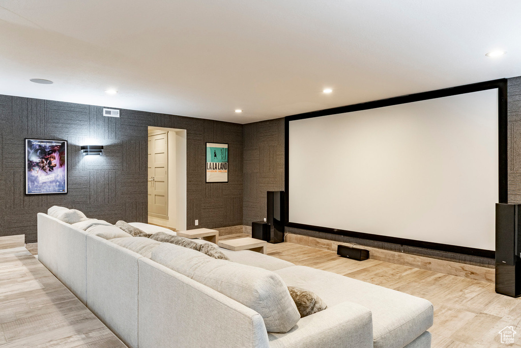 Cinema room featuring light wood finished floors and recessed lighting