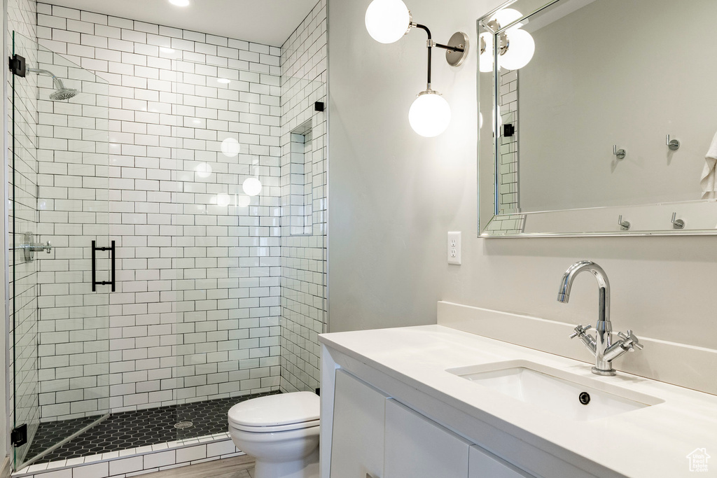 Full bathroom featuring a stall shower and vanity